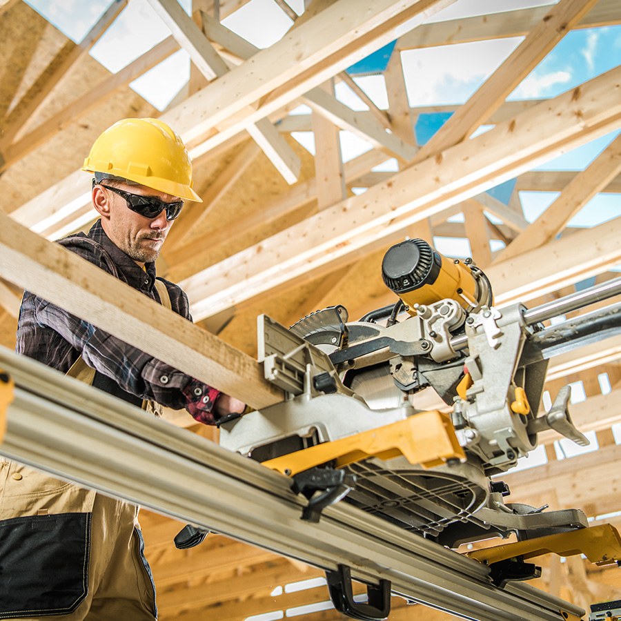 Worker cutting wood for framing