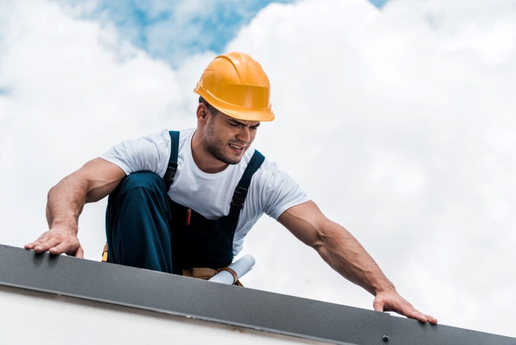 Roofing contractor inspecting a residential roof as part of roofing services.